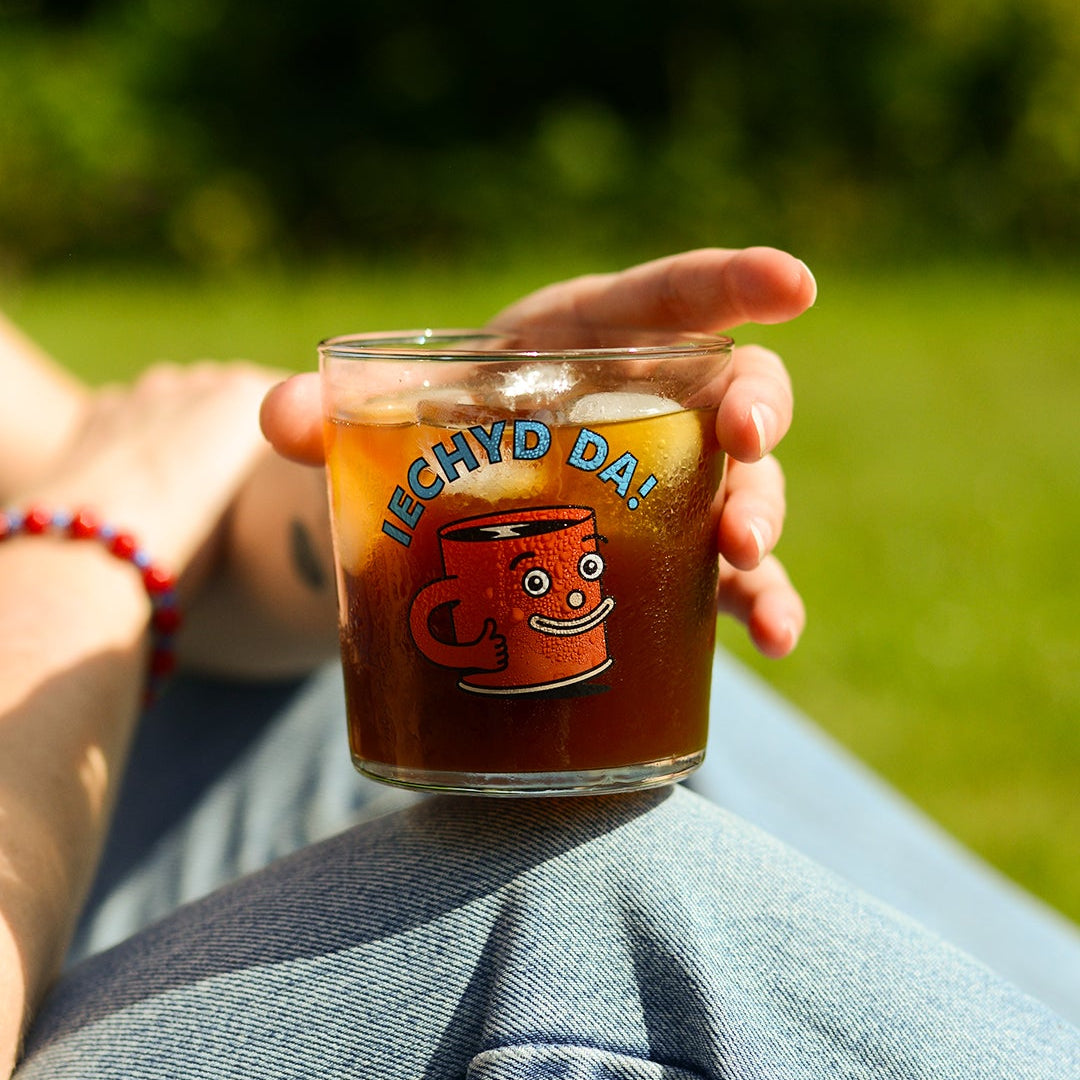 iechyd da glass, featuring Cuppy the Hard Lines Coffee Mascot.
